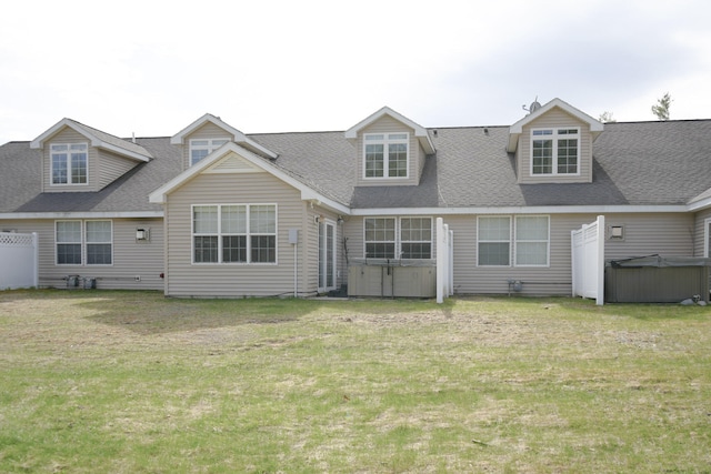 back of house featuring a lawn