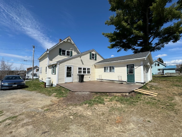 back of house with a deck