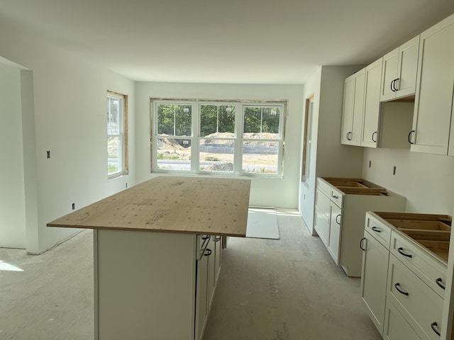 kitchen with a center island and white cabinetry