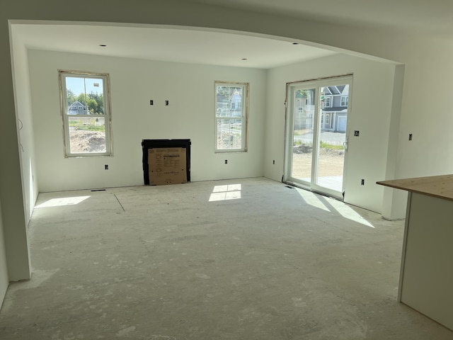 unfurnished living room featuring a healthy amount of sunlight