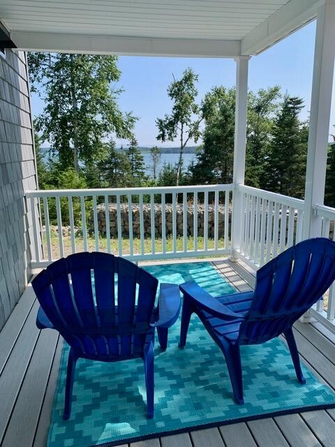 wooden deck featuring a water view