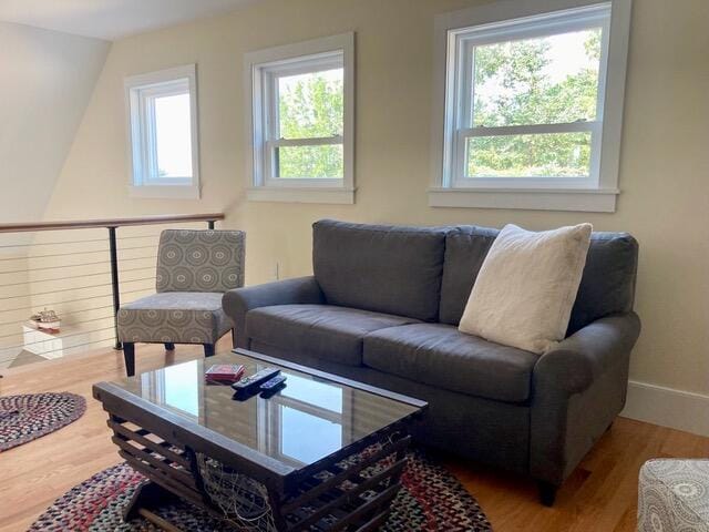 living room with plenty of natural light, baseboards, and wood finished floors