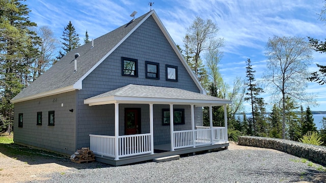 view of front of property featuring a shingled roof and covered porch