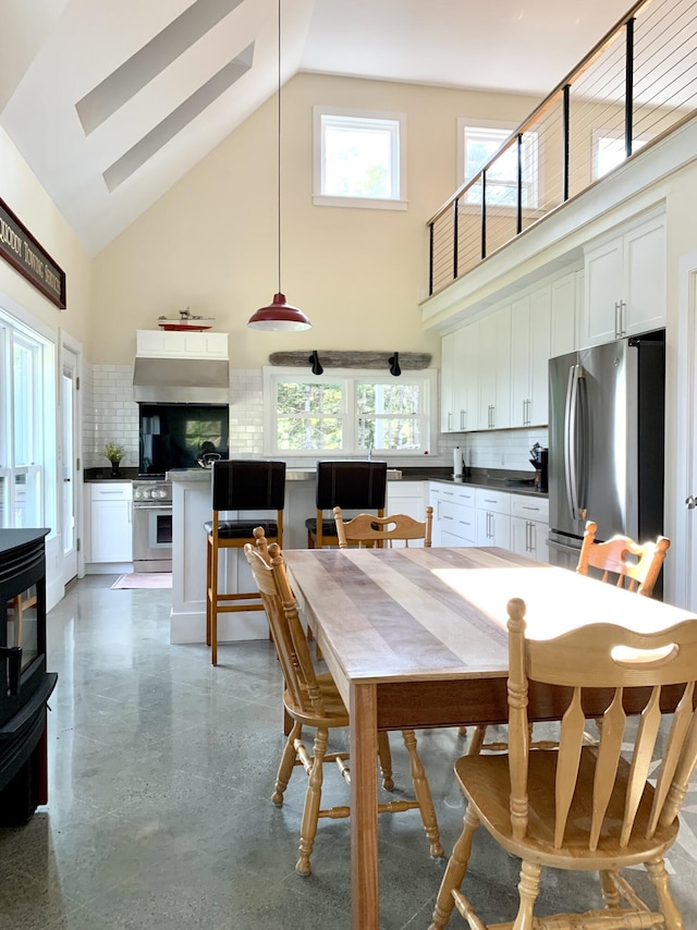 dining room with a towering ceiling