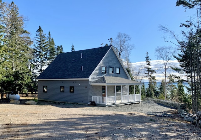 back of property featuring covered porch