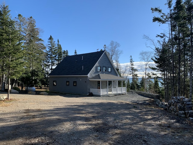 rear view of property with covered porch