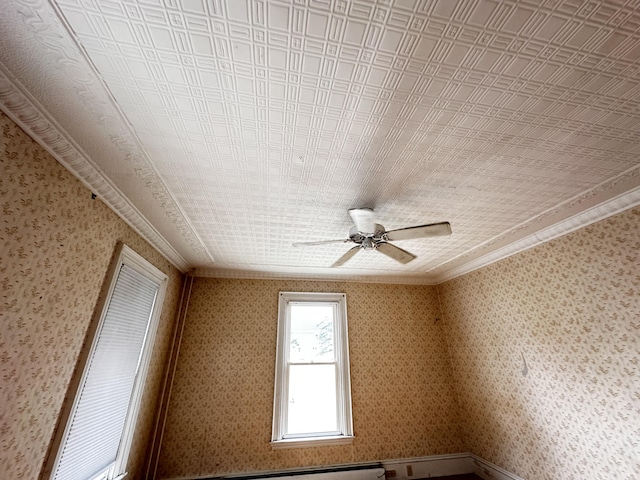 spare room featuring ceiling fan and ornamental molding