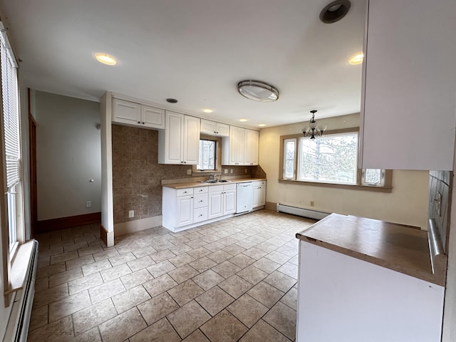 kitchen featuring a baseboard heating unit, white cabinets, light tile flooring, backsplash, and white dishwasher