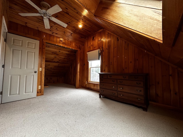 bonus room with wood walls, vaulted ceiling, ceiling fan, carpet flooring, and wood ceiling