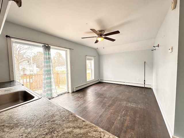 unfurnished room with ceiling fan, sink, dark wood-type flooring, and vaulted ceiling