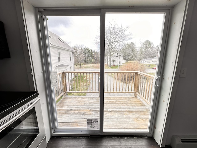 doorway to outside with a healthy amount of sunlight and a baseboard radiator