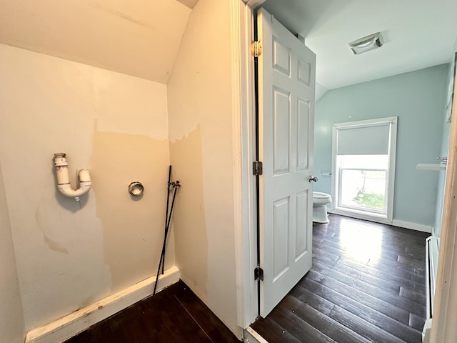 bathroom with hardwood / wood-style flooring and toilet