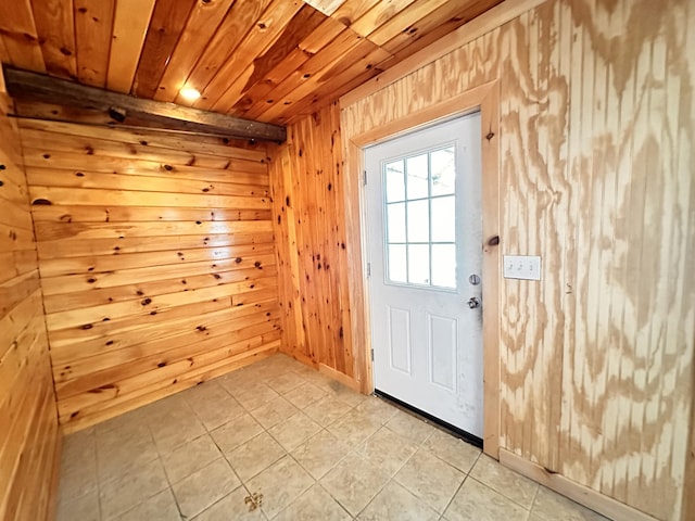 doorway with wooden ceiling, wood walls, and light tile floors