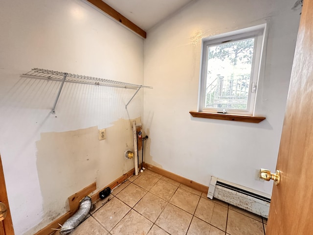 clothes washing area with light tile floors and a baseboard radiator