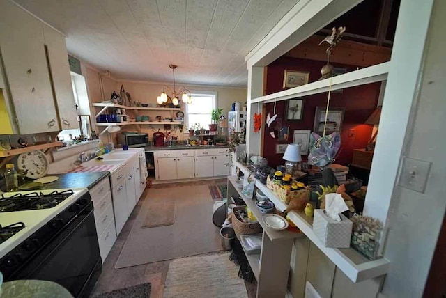 242 Crescent Park Rd, New Limerick, ME 04761 - kitchen featuring white cabinetry, decorative light fixtures, gas range gas stove, a notable chandelier, and sink