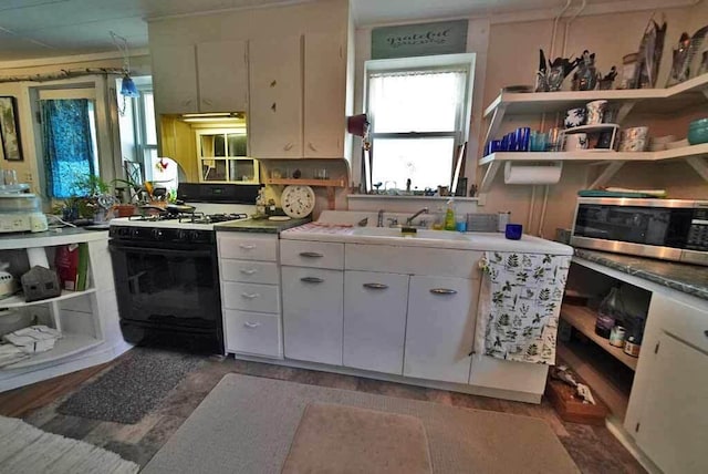 242 Crescent Park Rd, New Limerick, ME 04761 - kitchen featuring white cabinetry, white gas range, and sink