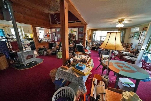 242 Crescent Park Rd, New Limerick, ME 04761 - interior space featuring ceiling fan, a wood stove, and carpet floors
