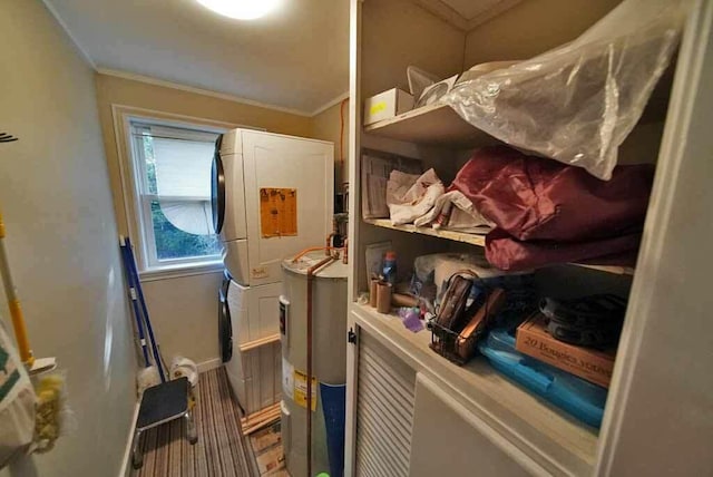 242 Crescent Park Rd, New Limerick, ME 04761 - storage room with stacked washer and clothes dryer and electric water heater