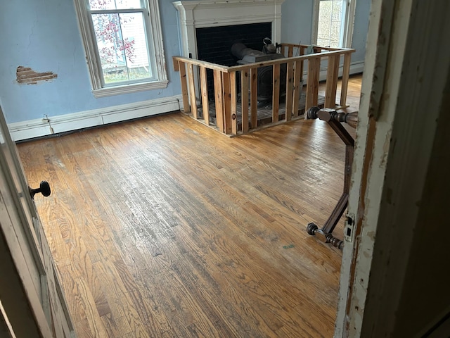 interior space featuring hardwood / wood-style flooring and a baseboard heating unit