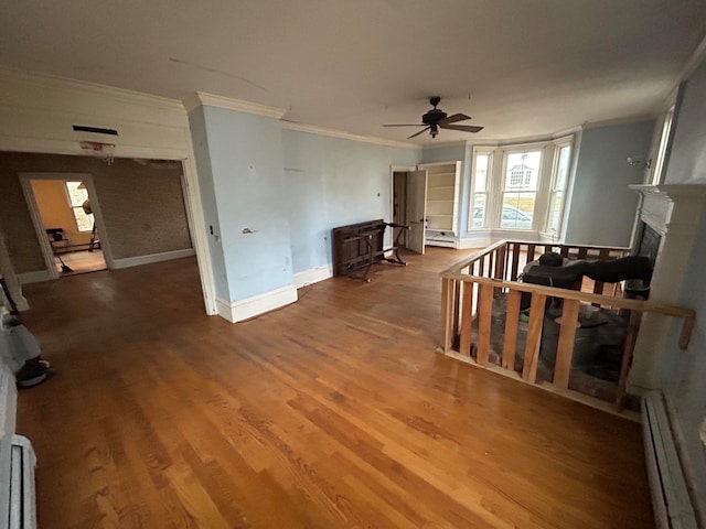 living room featuring ceiling fan, hardwood / wood-style floors, crown molding, and a baseboard heating unit