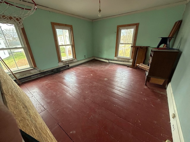 spare room featuring dark hardwood / wood-style flooring, ornamental molding, and a baseboard radiator