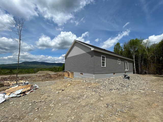 view of side of home with a mountain view