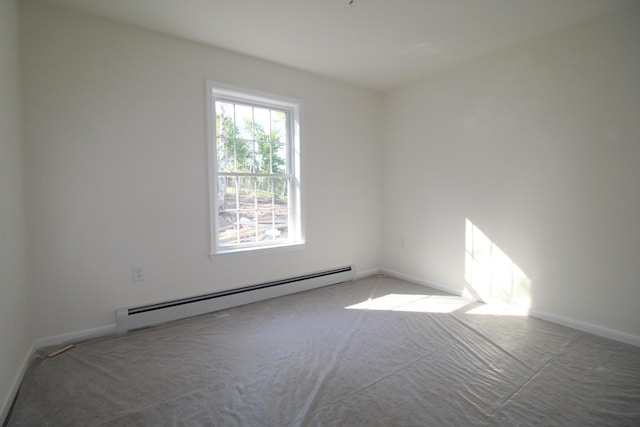 carpeted empty room with baseboard heating