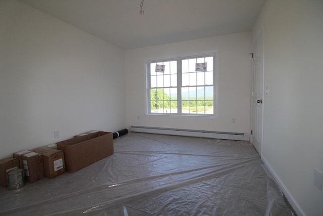 empty room featuring a baseboard heating unit