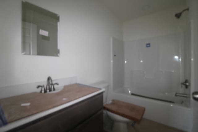 full bathroom featuring vanity, toilet, and bathtub / shower combination