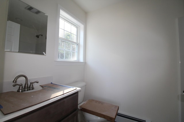 bathroom featuring vanity, toilet, walk in shower, and a baseboard radiator