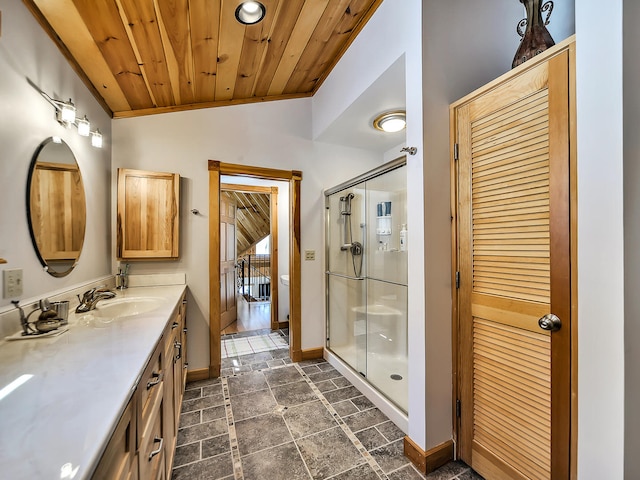 bathroom with vanity, vaulted ceiling, walk in shower, and wood ceiling