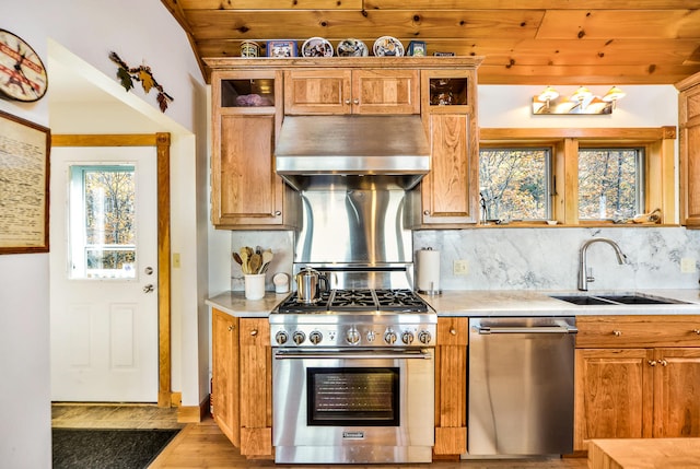 kitchen with wood ceiling, backsplash, exhaust hood, and stainless steel appliances