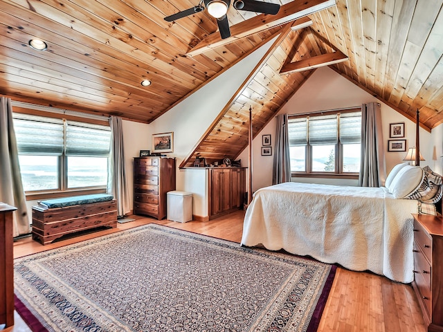 bedroom featuring ceiling fan, wooden ceiling, vaulted ceiling with beams, light hardwood / wood-style floors, and multiple windows