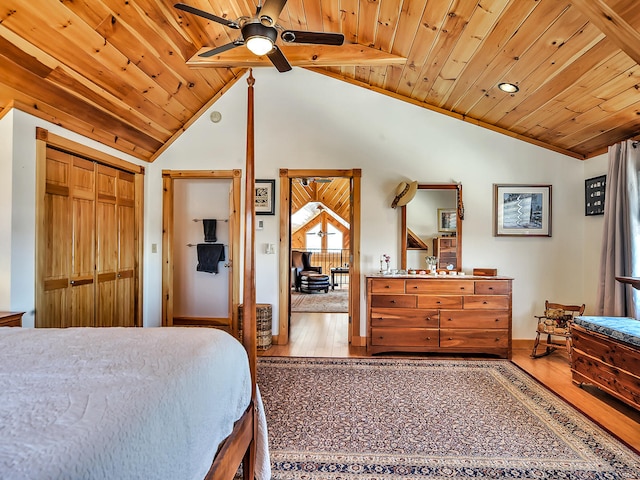 bedroom featuring hardwood / wood-style floors, vaulted ceiling, ceiling fan, wood ceiling, and a closet