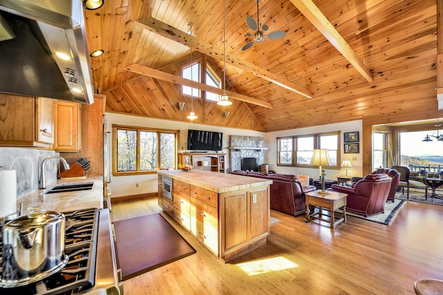 kitchen featuring beam ceiling, ceiling fan, sink, wooden ceiling, and ventilation hood