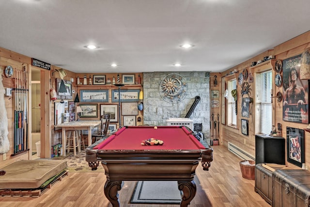 recreation room with wooden walls, light hardwood / wood-style floors, billiards, and a baseboard radiator