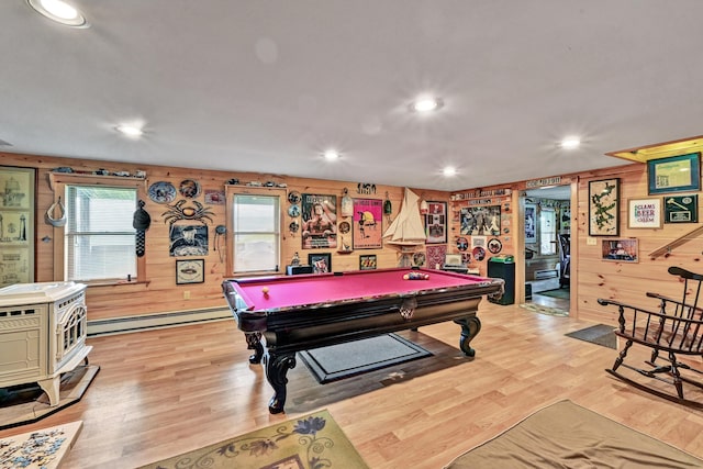 recreation room featuring a wood stove, wood walls, light hardwood / wood-style flooring, and pool table