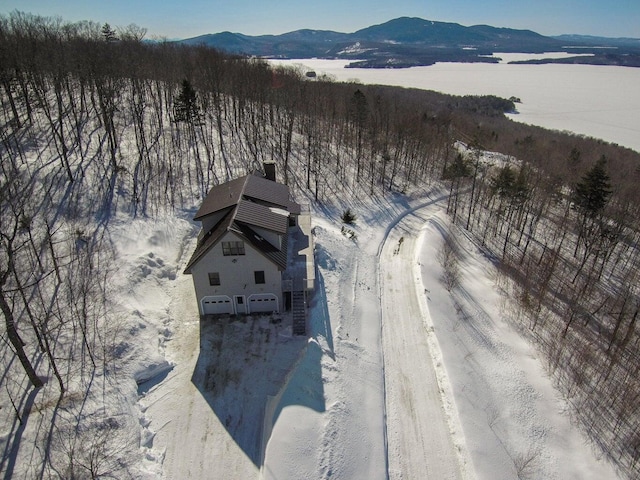 snowy aerial view featuring a mountain view