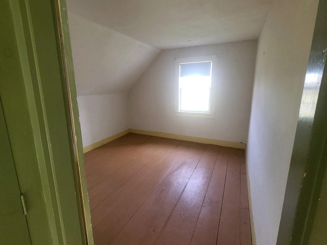 bonus room with vaulted ceiling and hardwood / wood-style flooring