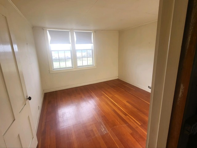 unfurnished room featuring ornamental molding and hardwood / wood-style flooring