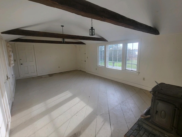 interior space featuring vaulted ceiling with beams, light wood-type flooring, and a wood stove