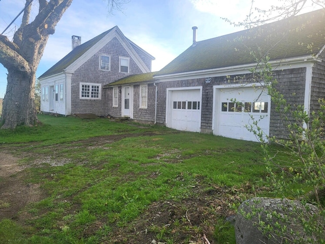 view of front of home with a garage and a front lawn