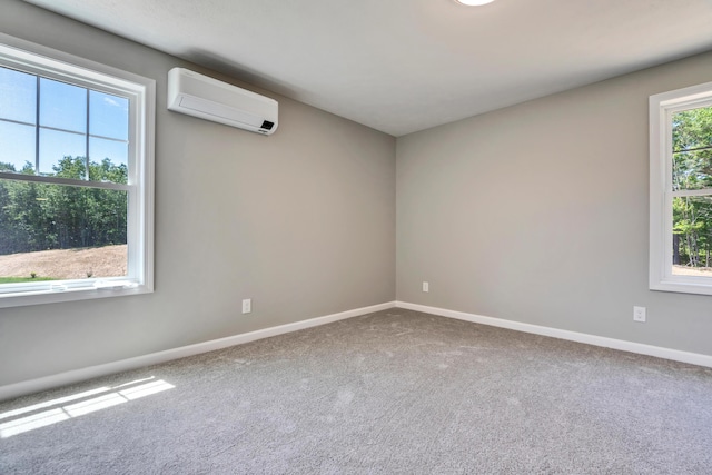 unfurnished room with carpet floors and a wall mounted AC