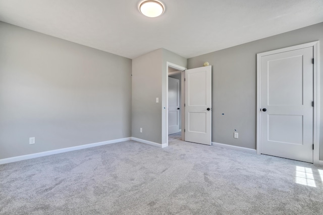 unfurnished bedroom featuring light carpet