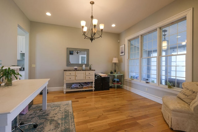 interior space featuring an inviting chandelier, recessed lighting, light wood-style flooring, and baseboards