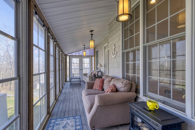 unfurnished sunroom featuring vaulted ceiling