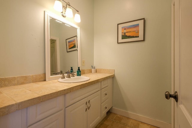 bathroom with baseboards and vanity