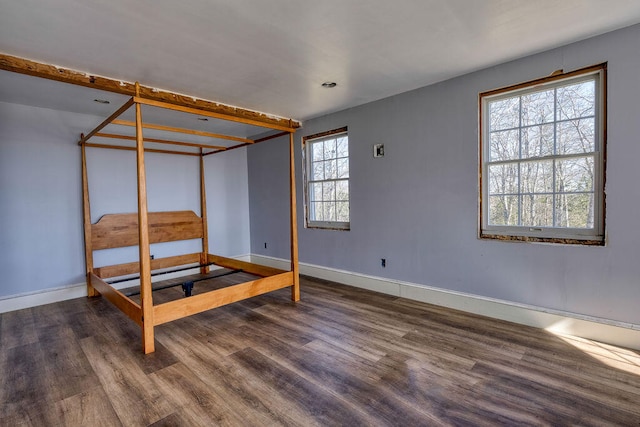 bedroom featuring dark wood finished floors and baseboards