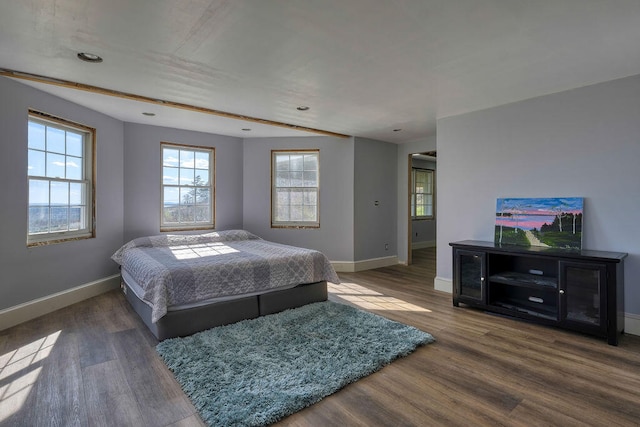 bedroom featuring baseboards and wood finished floors