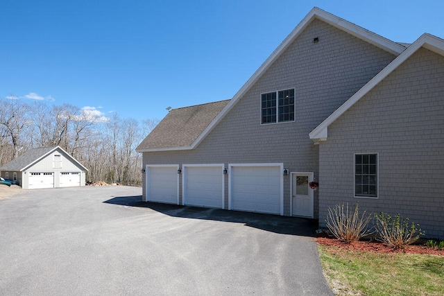 view of home's exterior featuring a garage and aphalt driveway